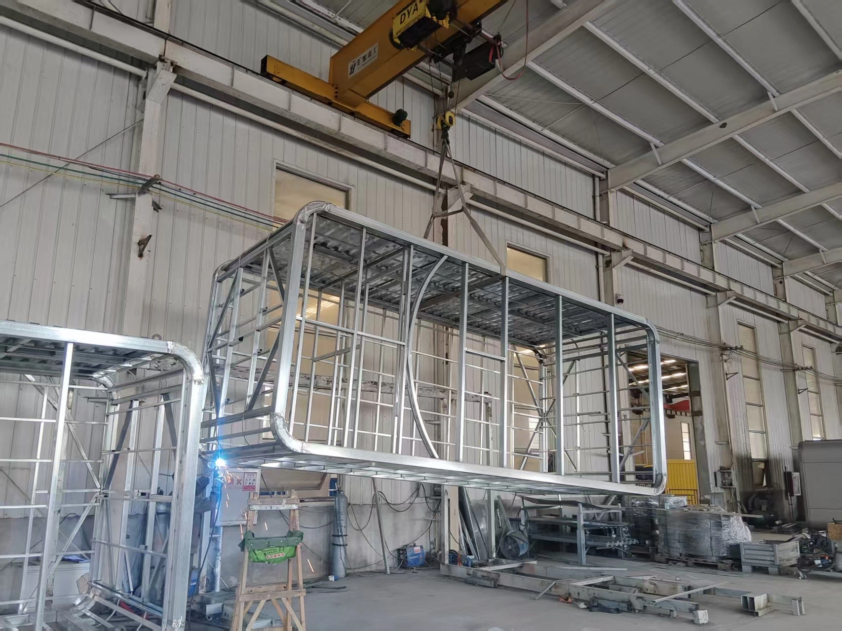 Factory photograph showing the welded pod structure before cladding